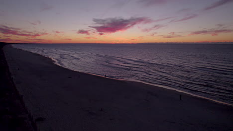 aerial view of tranquil waves reaching beach after