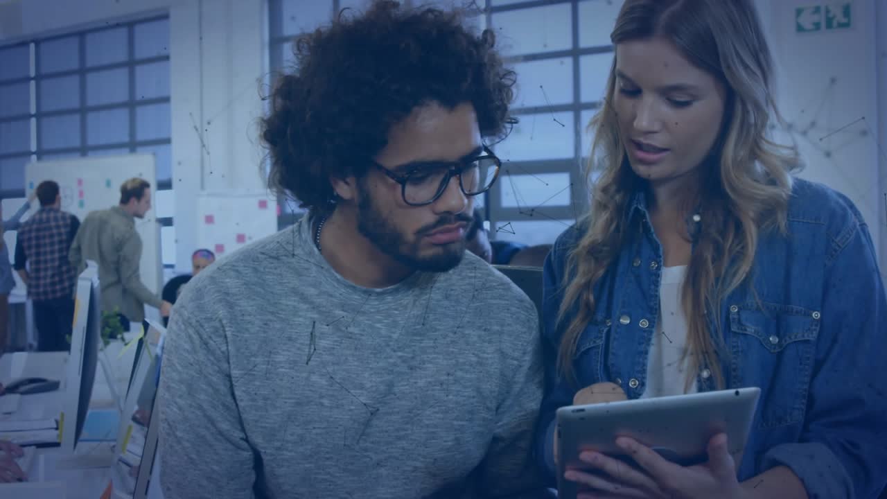 Woman walking office, tapping tablet and causing animated charts showing design status for teammate