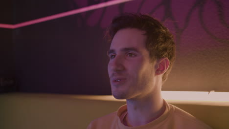 close up view of excited boy playing video games sitting on sofa at home