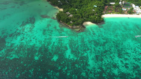 Exotic-Koh-Phi-Phi-coastline-with-white-beaches,-clear-turquoise-water-and-tropical-reefs