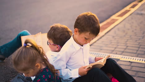 young-serious-guys-study-outdoors-sitting-on-coloured-bags