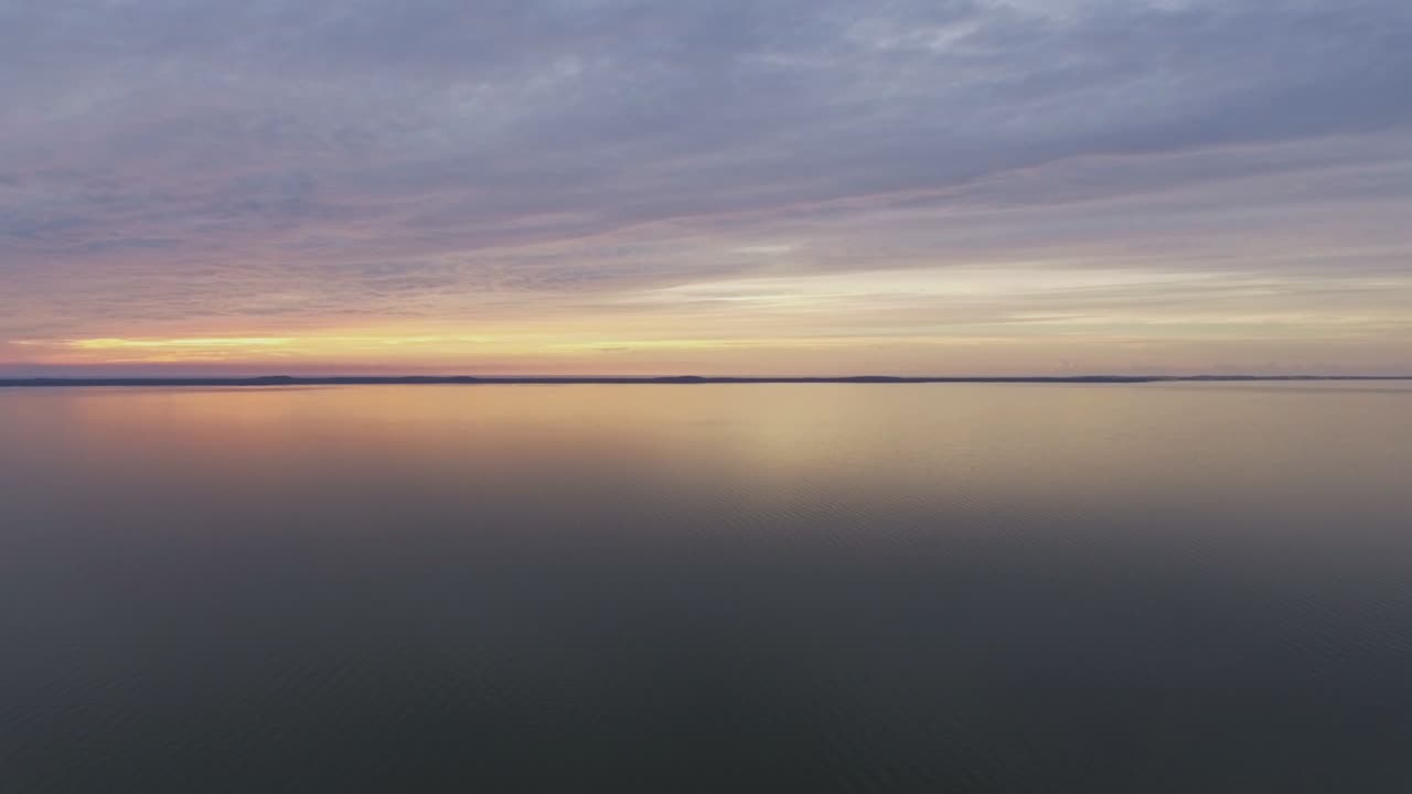 Curonian Lagoon and Thin Sand Dunes Curonian Spit At Sunset. Aerial Slow Pan Right