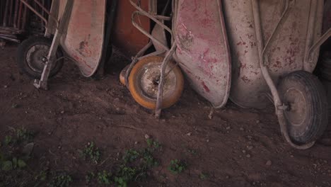 pile of old and dirty wheelbarrows