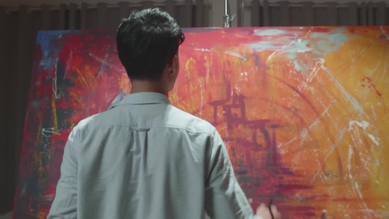 Talented Male Artist Energetically And Violently Using Paint Brush He Creates Modern Masterpiece Of The Painting