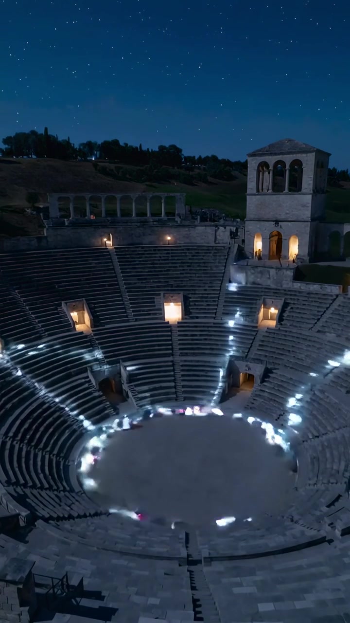 Vertical video: Lighting lanterns, performers circling amphitheater for light ritual, tower glowing