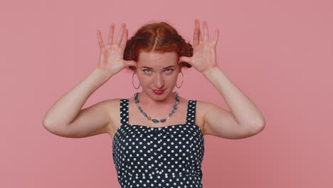 redhead woman showing tongue making faces at camera, fooling around, joking, aping with silly face