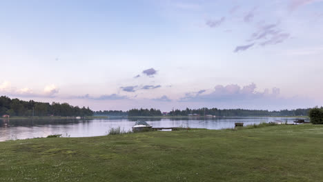 Green-Grass-Shoreline-and-Finnish-Archipelago-Under-Dramatic-Summer-Sky-at-midnight,-concept-of-nordic-cottage-culture