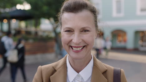 portrait of elegant mature business woman smiling confidently in urban background wearing stylish suit jacket