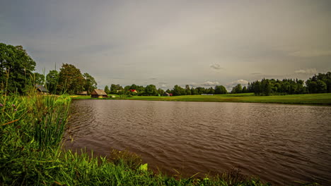 Timelapse-of-clouds-moving-over-a-lake-on-a-partly-cloudy-day