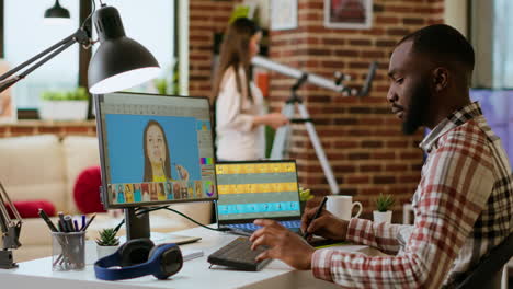 African-american-photo-editor-retouches-images-on-his-computer