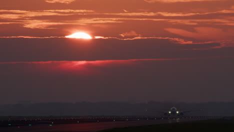 airplane landing/taking off at sunrise/sunset