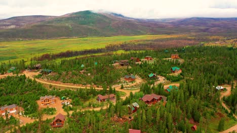 casas de montaña rodeadas de bosque de pinos en las montañas rocosas en un día nublado de verano