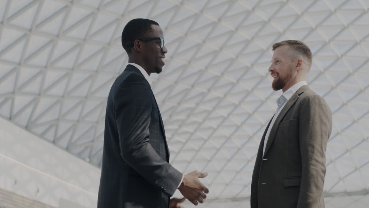 Businessmen shaking hands in modern building