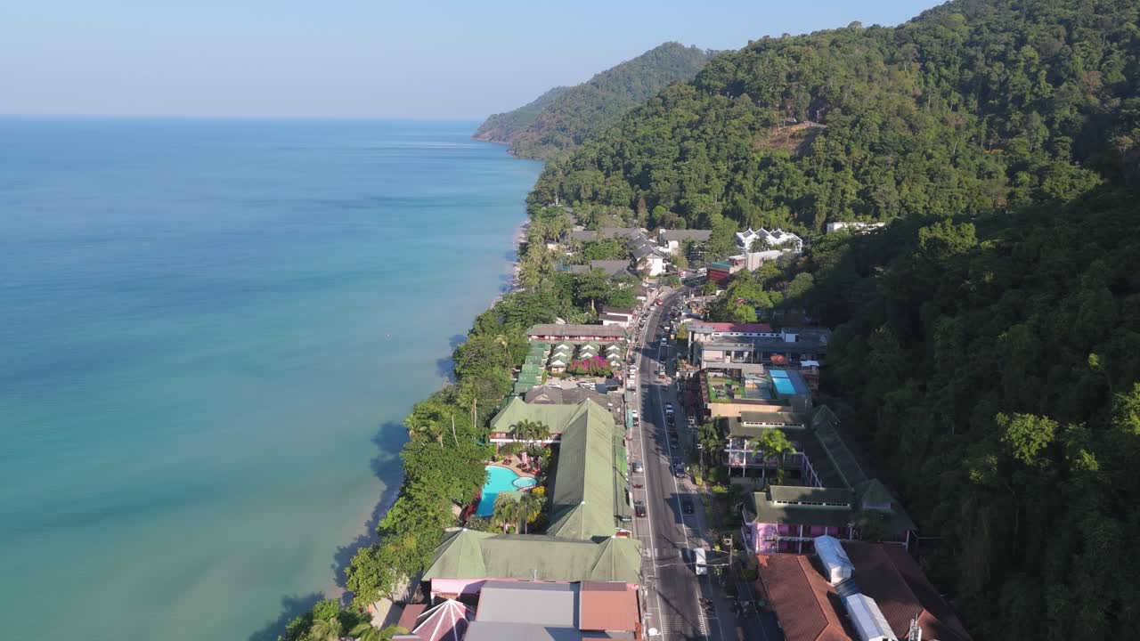 Aerial drone footage of White Sand Beach village, Koh Chang, Thailand. Capturing sunny morning views of the coast and tropical scenery