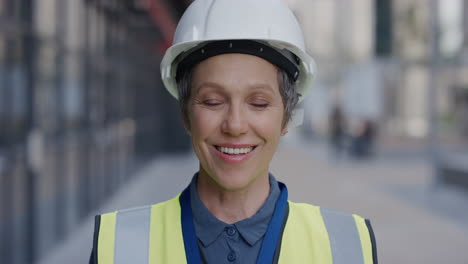 portrait successful senior construction engineer woman smiling enjoying professional career success wearing hard hat safety helmet slow motion reflective clothing