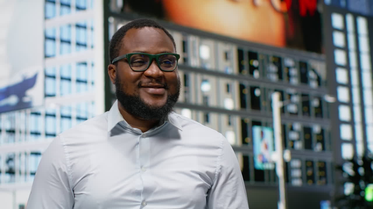 Stylish black man enjoying casual downtown walk on a lively street