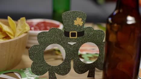 close up of irish novelties and props including shamrock shaped glasses celebrating at st patrick's day party