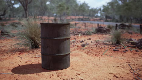 old-empty-rusted-barrel-on-sand