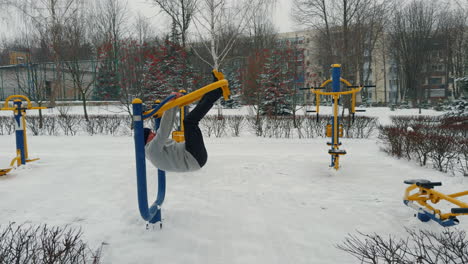 senior caucasian man swaying back and forth on the sport simulator. adult sportsman practicing on the sports ground in winter.