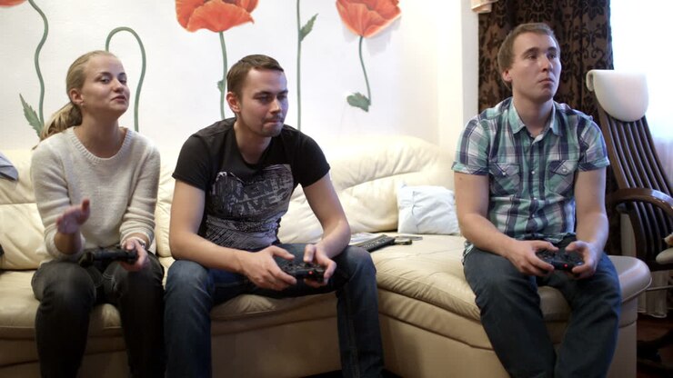 Two men and girl playing video game