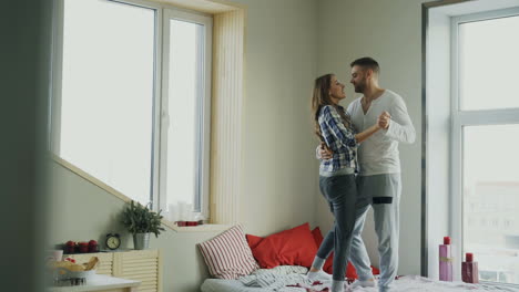 couple dancing in a cozy bedroom