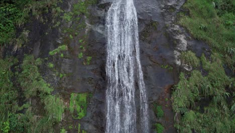 bonao jima falls, water flowing over rocks in middle of forest