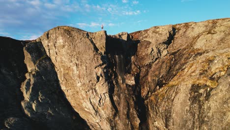 Aerial-Pedestal-Up-Sunlit-Cliff-Face-At-Hardangervidda-National-Park,-Eidfjord,-Norway