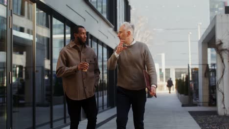 two businessmen walking and talking