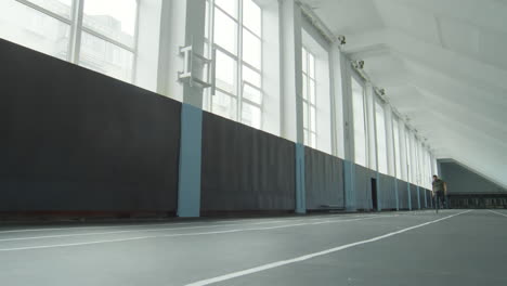 professional runner with prosthetic leg training in stadium