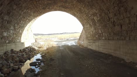 going under a rock bridge on an abandoned farm land in colorado