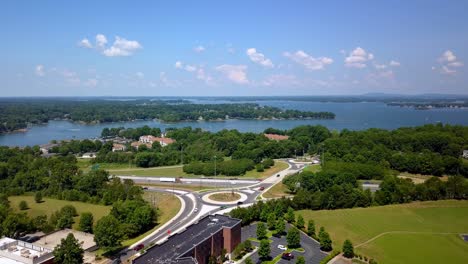 Aerial-Roundabout-in-Davidson-NC,-Davidson-North-Carolina-with-Lake-Norman-in-Background,-Lake-Norman-NC,-Lake-Norman-North-Carolina