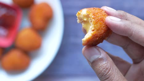 close up of chicken cheese meat ball on hand