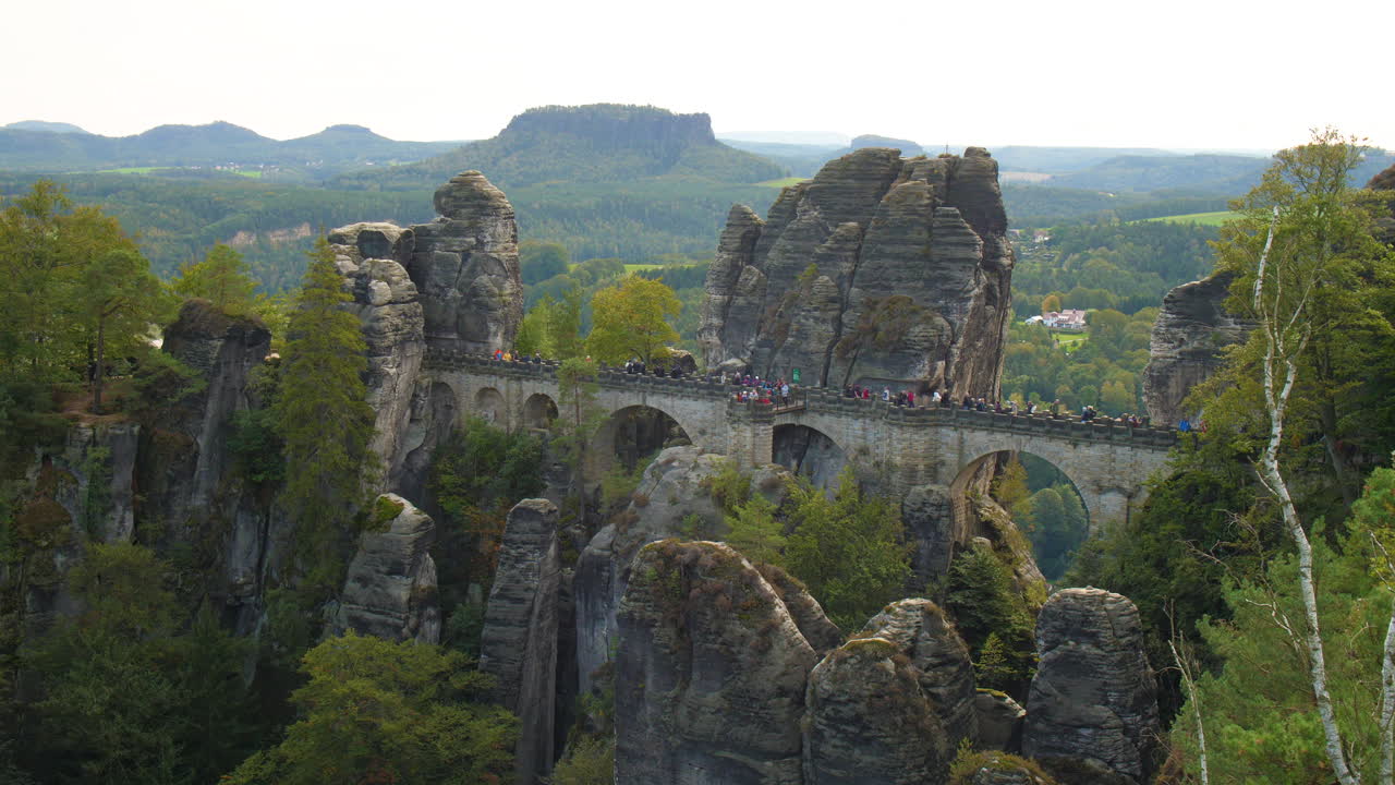 Bastei Elbsandsteingebirge Sachsen Elbe sandstone formations rising above dense green forests Mountains, showcasing the region’s natural beauty and rugged Terrain