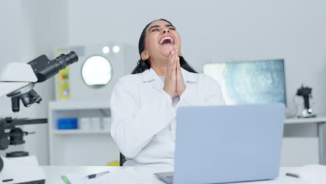 Excited-female-scientist-cheering-in-a-lab