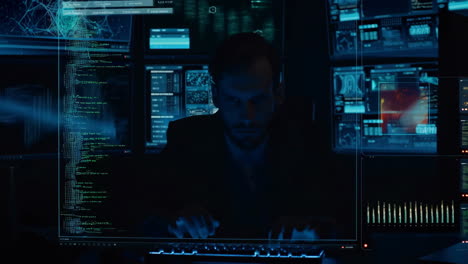 man analyzing data on multiple futuristic computer screens in a dark room