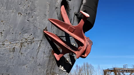 closeup view of slightly rusty red iron anchor of heavy ship