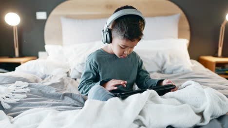 Boy,-child-and-tablet-with-headphones-in-bedroom