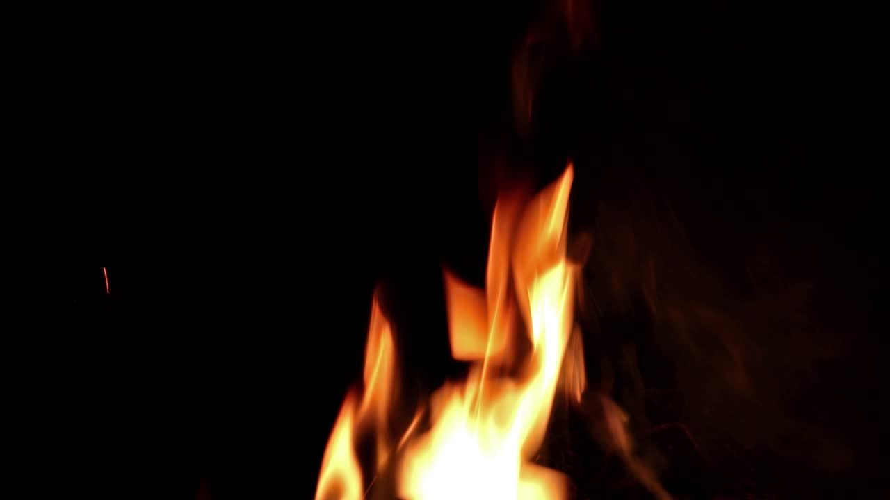 Fire flames on a black background. Abstract fiery texture. Realistic fire flames burn movement frame. Texture of fire for Design.