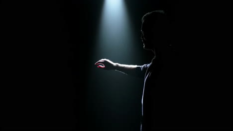 silhouette of a man in a spotlight