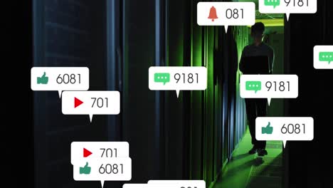 Animation-Von-Social-Media-Symbolen-Und-Zahlen-über-Einem-Asiatischen-Männlichen-IT-Techniker-Durch-Einen-Computerserver