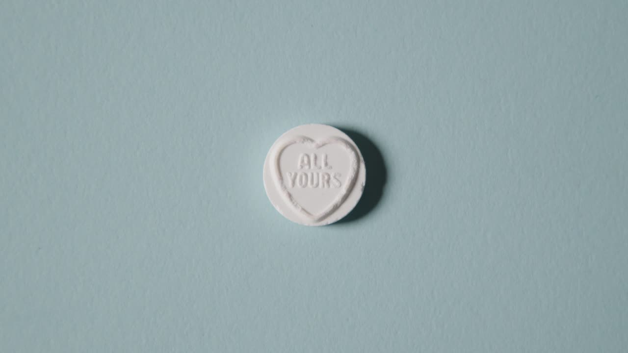 Hand Picking Up Heart Candy With All Yours Message On Blue Background