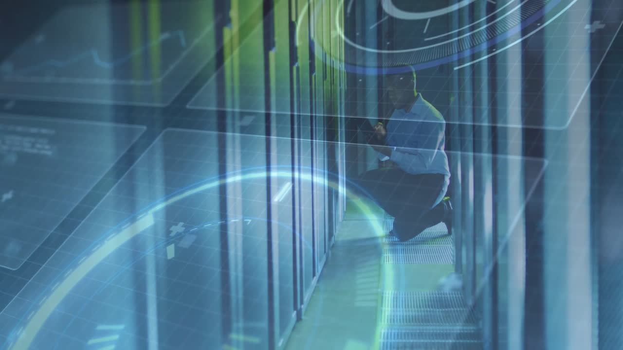 Male technician kneeling in aisle between server racks, inspecting hardware with holographic graphs