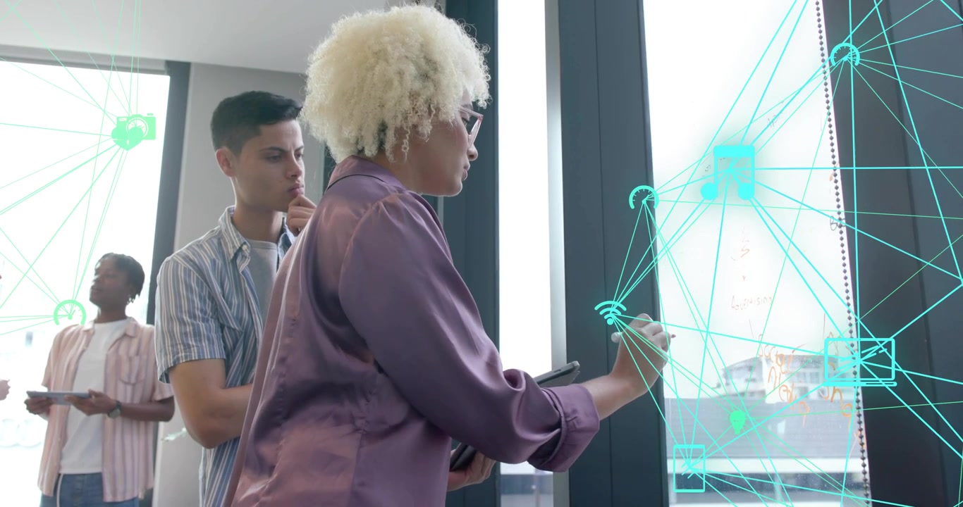 Designer tapping tablet generating neon green network design on glass for business collaboration