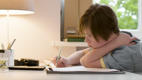 young girl studying and writing on paper