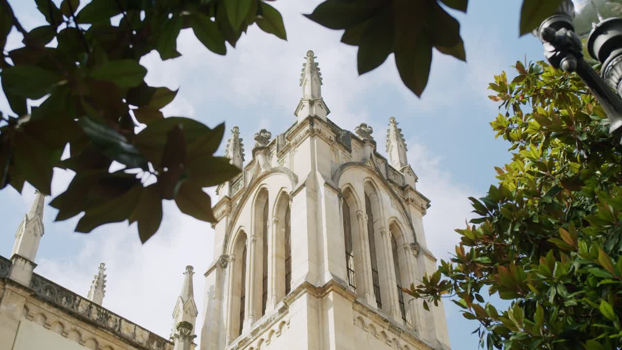 Side view of the bell tower of San Lorenzo's Church in Gijon, Asturias - Handheld, Slow Motion