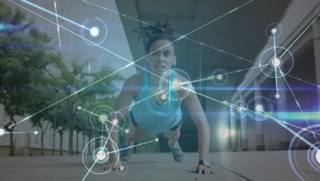 Animation-of-network-of-connections-over-woman-doing-push-ups-outdoors
