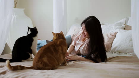 woman with cats in bed