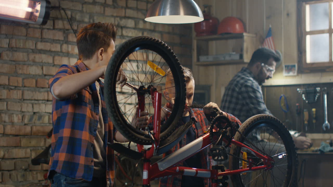 Kids repairing a bicycle in a garage
