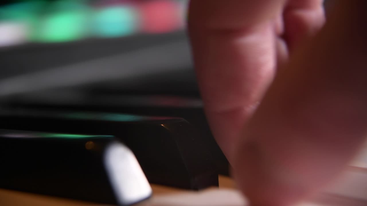 macro close up de las teclas y los dedos de un pianista mientras tocan a través del teclado