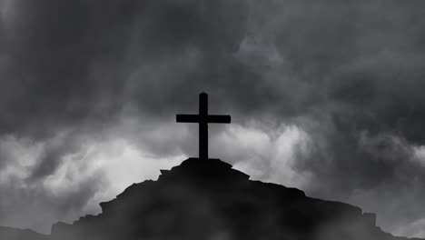 cross on rocky hilltop silhouette